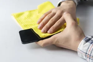 cleaning phone screen with microfiber cloth